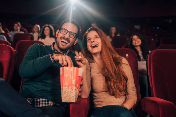 istock Smiling couple with popcorn in cinema 1053057474