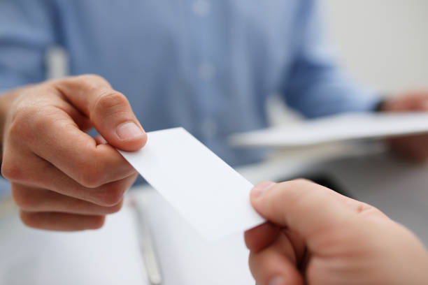 istock Male hand in suit give blank calling card tom man 1053059886