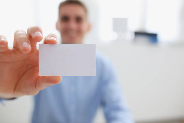 istock Smiling business man in suit hold in hand blank 1053059902