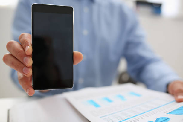 istock A businessman holds a new smartphone in his hand 1053059942