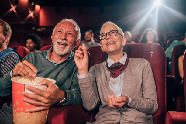 istock Older couple eating popcorn at cinema 1053060686