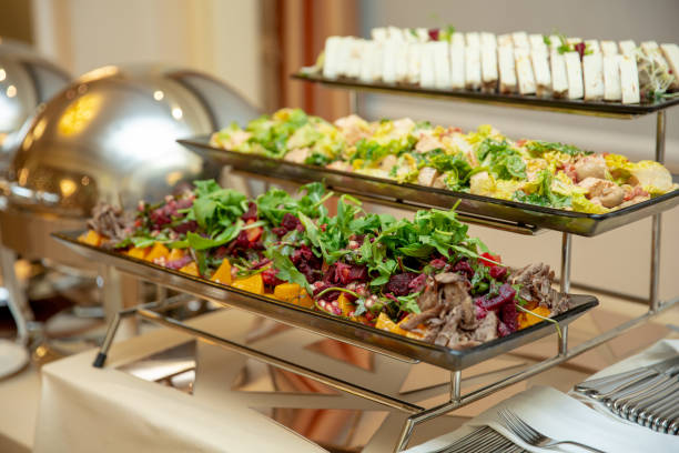 istock dishes with salad and meat snack at reception. 1053063320