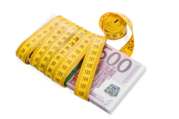 Hungarian forint banknotes and a shiny metal dumbbell held in hand. Ideal illustration when the Hungarian forint gets stronger. On the picture we wee a 500 Hungarian forint banknote, a 1000 Hungarian forint banknote and a 2000 Hungarian forint banknote. 3500 Hungarian forint altogether.