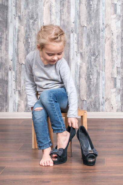 istock Little girl trying on shoes 1053065528
