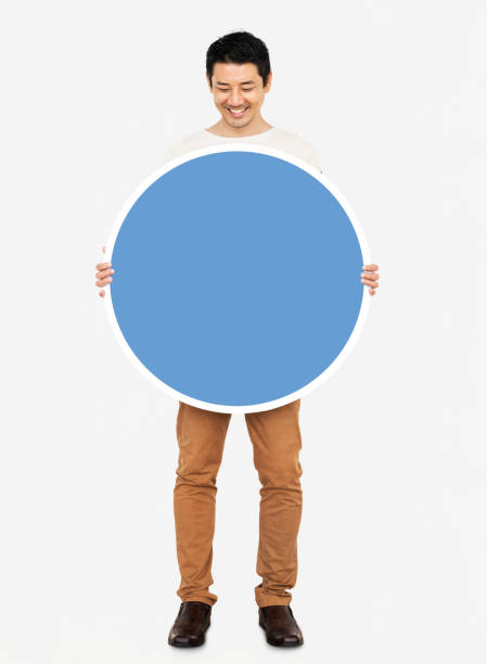 Cheerful man holding a blank blue circle