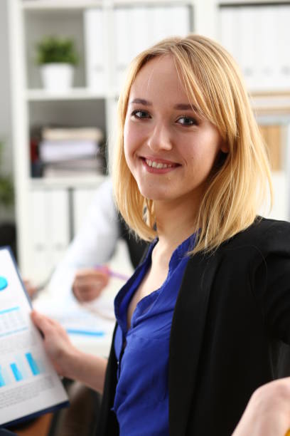 istock Beautiful smiling cheerful girl at workplace 1053069700