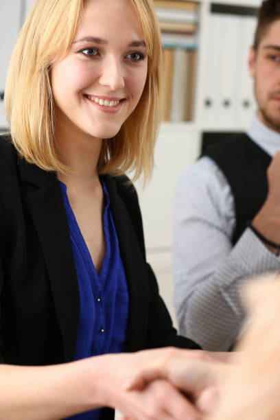 istock Businessman and woman shake hands as hello 1053070320