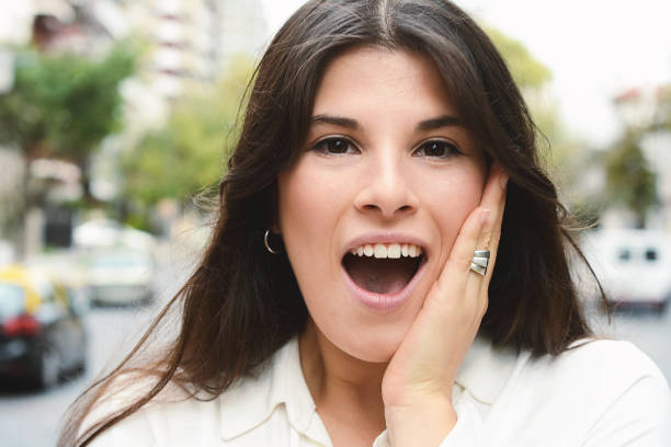 istock Young latin woman with surprised facial expression. 1053072162