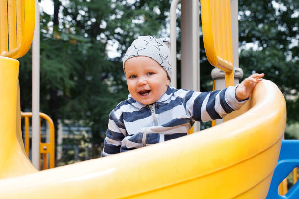istock Little child having fun on playground outdoors 1053076042