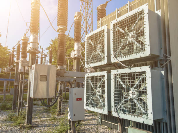 istock High voltage power transformer substation 115KV.high-voltage substation on blue sky background with switch.fan for Cooling High voltage power transformer. 1053087838