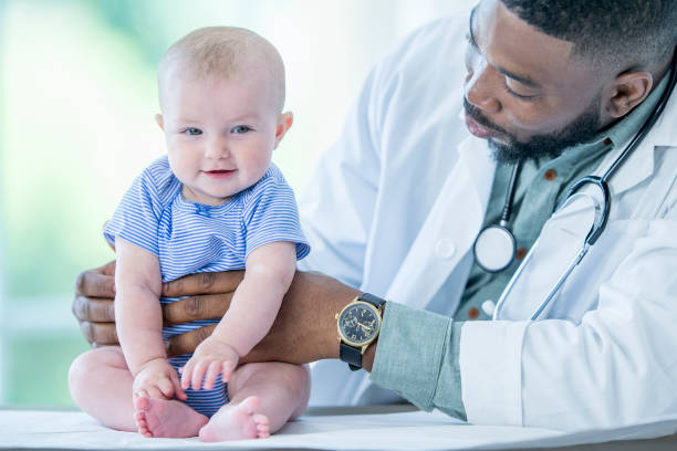 istock Doctor Holding Baby 1053098668