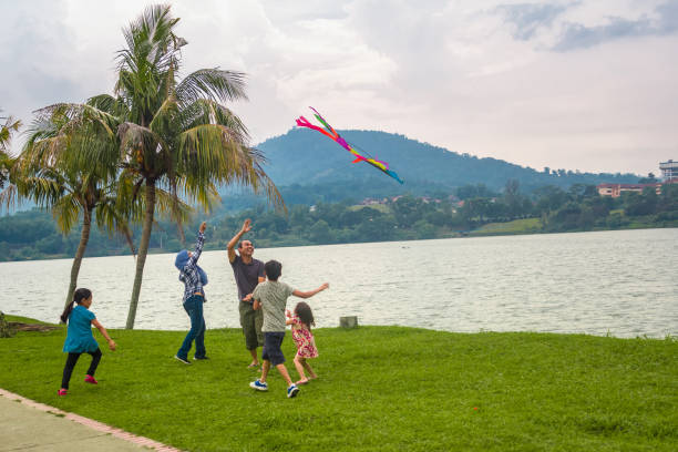 istock Kids try to chasing after the kite. 1053106396