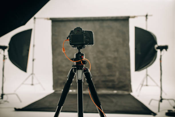 istock Digital camera mounted on a tripod in a photo studio 1053106724