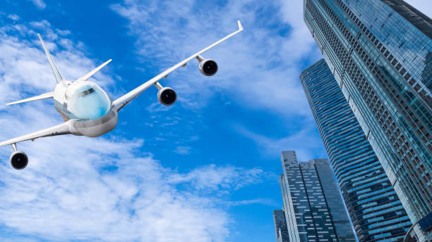 istock Airplane flying over modern building 1 1053106754