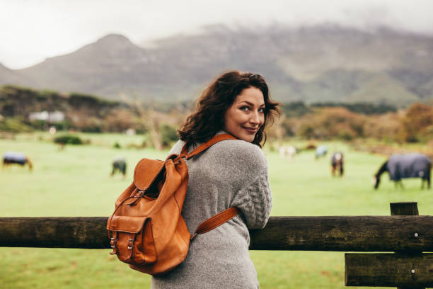 istock Woman standing by ranch fence 1053109090