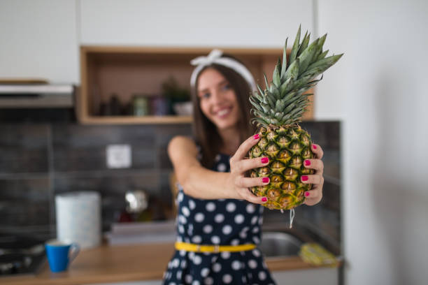 Beautiful woman holding pineapple
