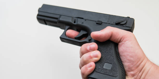 istock airsoft gun on a white background close-up. 
firearms practice concept 1053114080