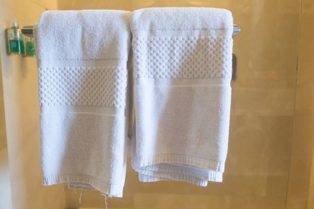 istock Clean white towels on a hanger at bathroom 1053119342