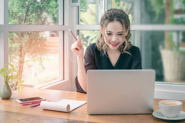 Happiness young business woman working in her office. stock photo