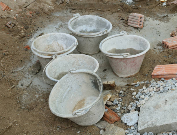 istock Old cement mixer bucket placed on a cement floor in the construction site. 1053125258
