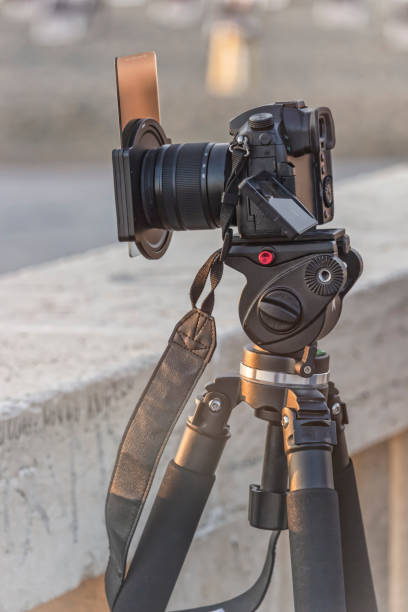 istock DSLR Camera pov, on a tripod shooting the sunset 1053127484