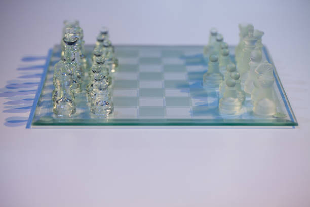 istock glass chess on the transparent chessboard 1053128824
