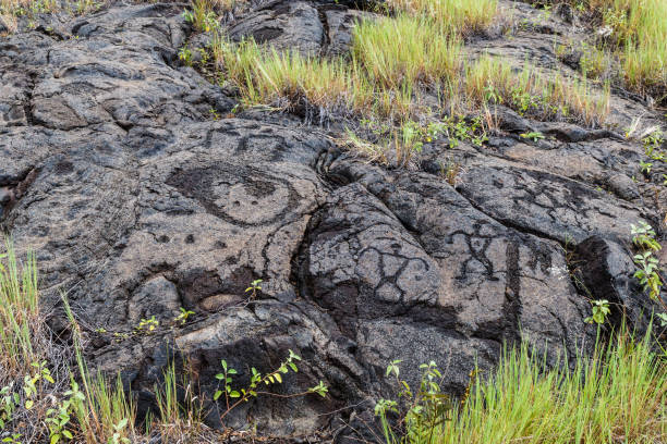 Petroglyphs in lava rock at Pu'uloa along Chain of Craters road, in volcano National Park on the island of Hawaii. Carvings are 400-700 years old. stock photo