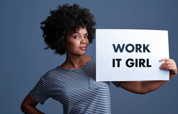 Quit looking for flaws, you're beautiful Studio shot of an attractive young woman holding a placard with the words “work it girl” on it youre beautiful quotes stock pictures, royalty-free photos & images