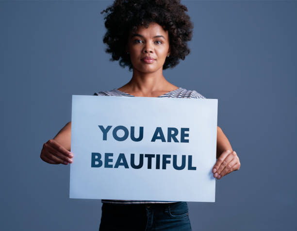 In case you need a reminder, you're beautiful Studio shot of an attractive young woman holding a placard with the words “you are beautiful” on it youre beautiful quotes stock pictures, royalty-free photos & images