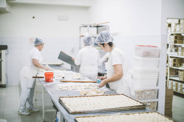 istock Women making pretzels in bakery 1053136162