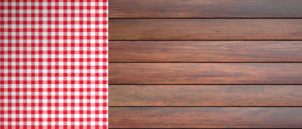 istock Red white checkered picnic tablecloth on wooden table, copy space. 3d illustration 1053136762