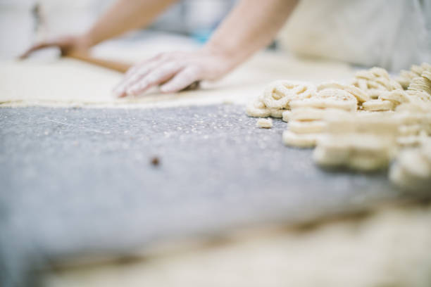 istock Woman making pretzels in bakery 1053139024