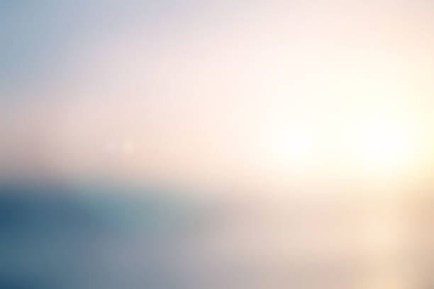 abstract blurred sea water surface background in sunrise hour with pastel ton e color and flare light for design as presentation , banner , ads concept