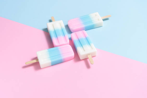 istock Homemade Fruit Ice cream stick , popsicle , ice pop or freezer pop with copyspace on blue and pink pastel background or texture 1053144316