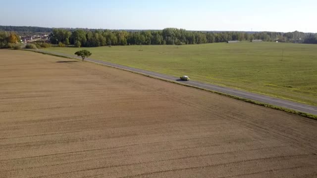 Drone shot vehicle traveling road.