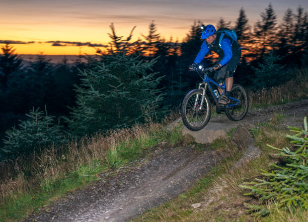 istock Mountain biking jump at sunset 1053145010