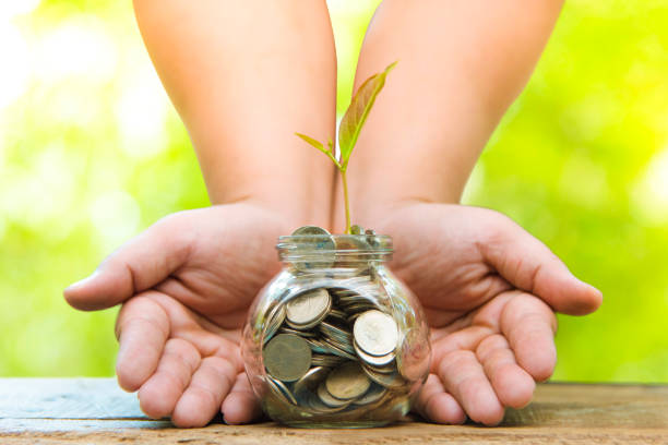 istock Trees with money, saving money and growing hands. 1053145450