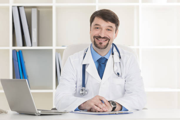 istock Male doctor working at office desk 1053147586