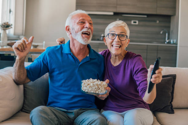 istock Couple eating popcorn and watching TV 1053157920