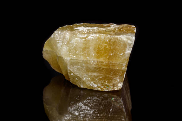 istock Macro mineral stone yellow Calcite on a black background 1053158048