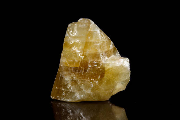 istock Macro mineral stone yellow Calcite on a black background 1053158430