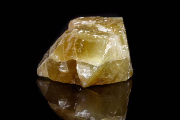istock Macro mineral stone yellow Calcite on a black background 1053159038