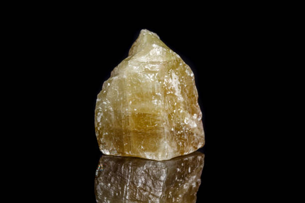 istock Macro mineral stone yellow Calcite on a black background 1053160968