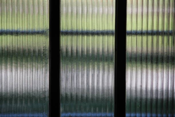 Closed blinds on a high-rise façade in various subtle colours