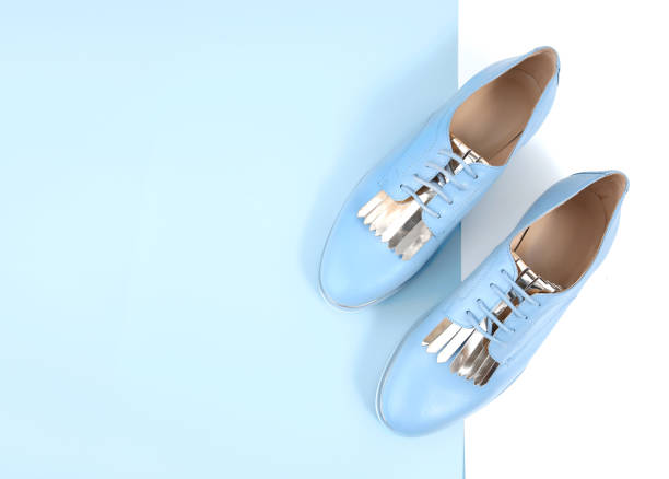 Blue women's leather shoes with laces top view empty space background.