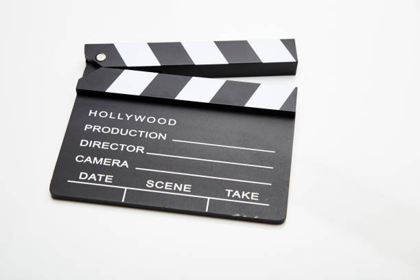 istock Film slate lying open against white 1053173112