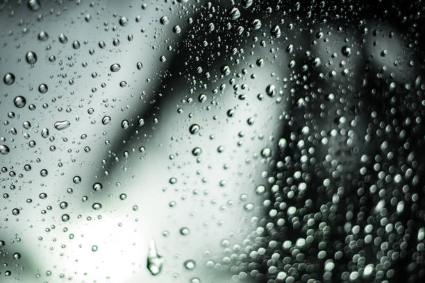 istock Water dripping on a glass. Drops on window glass.Use as background image for presentation. 1053173612