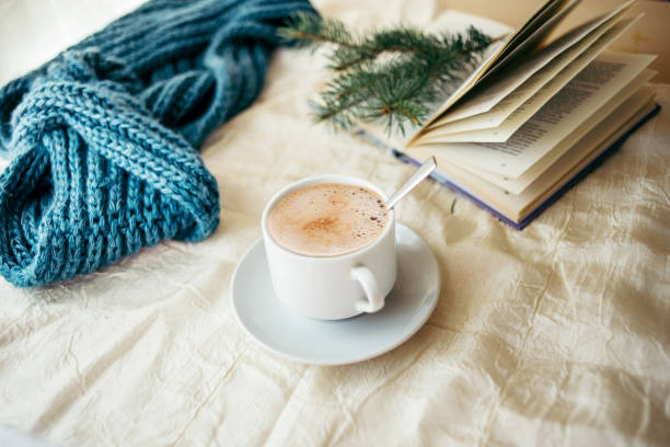 istock cup of tea with milk on a textile background with a knitted sweater and  needles 1053173910