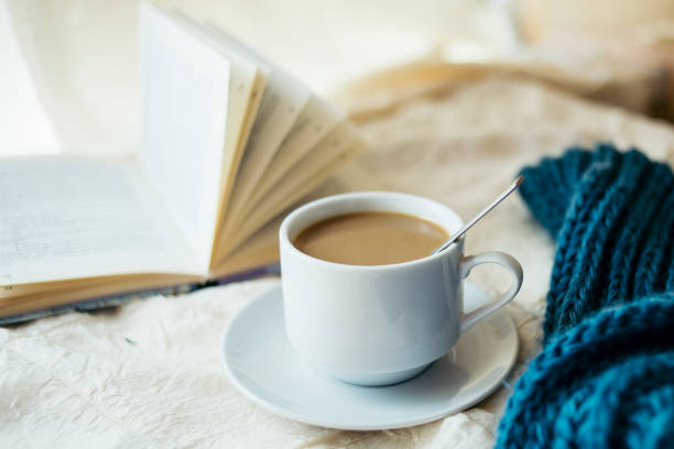 istock cup of tea with milk on a textile background with a knitted sweater and  needles 1053173972