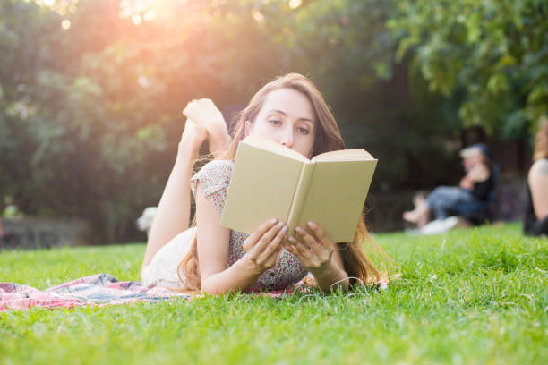 istock Young woman reading a book 1053175814